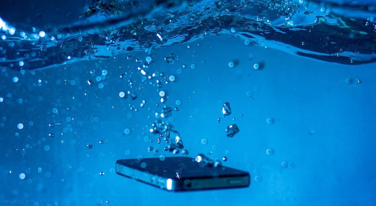 Free Black Mobile Phone under Blue Water Stock Photo