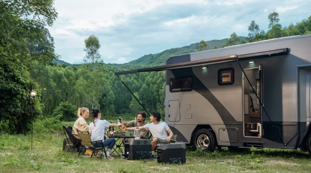 A group of people is picnicking in front of their RV and using EcoFlow portable power station. 